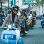 Group of friends riding classic scooters in Bangkalan, East Java, showing camaraderie and adventure.