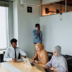 Diverse team engaged in collaborative work in a modern office environment, illustrating professionalism and inclusivity.